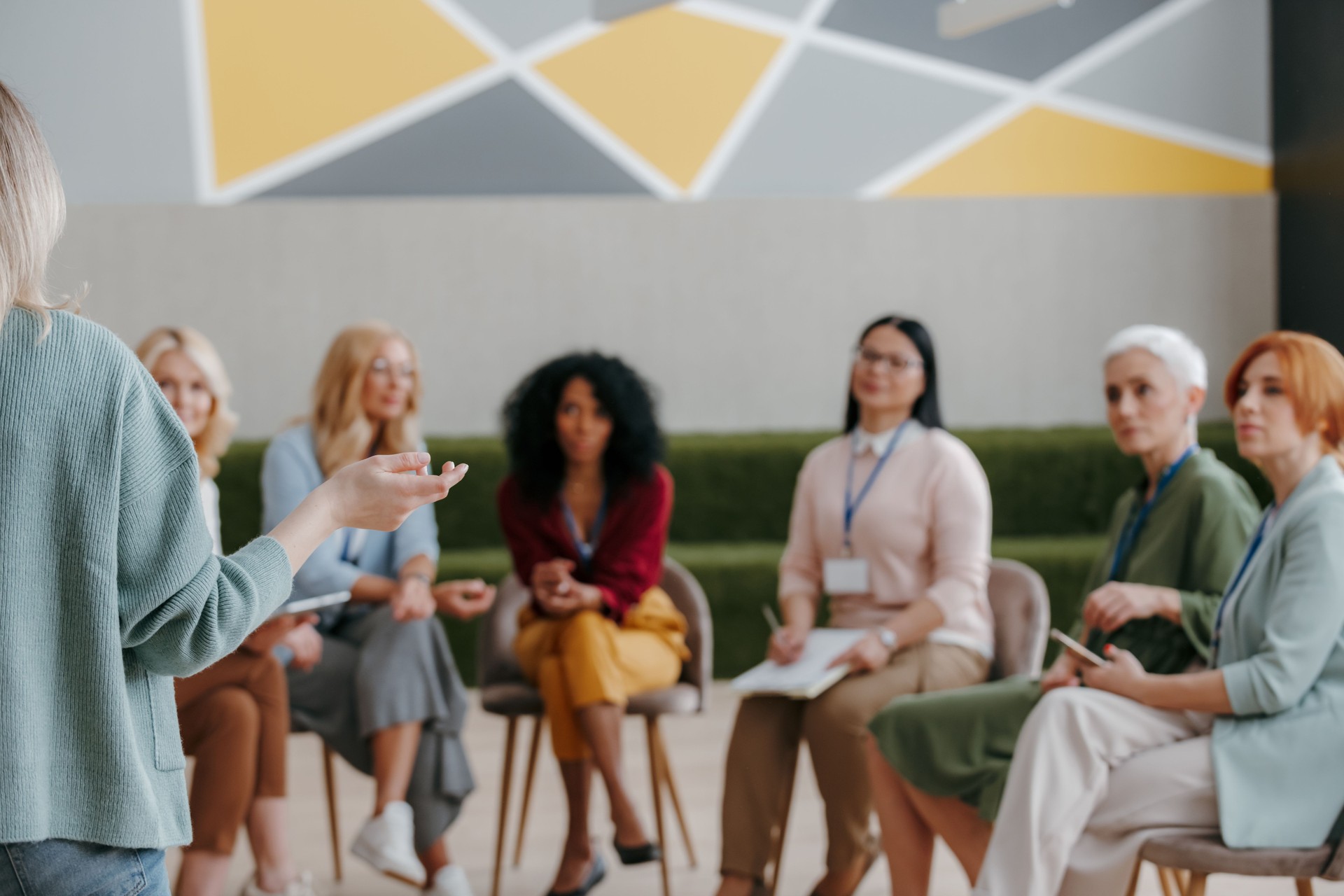 Group of mature women listening to speaker while visiting business conference